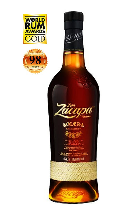 A bottle of Don Zacapa Bolera Grand Reserva rum on a white background, featuring award badges in the top left corner.